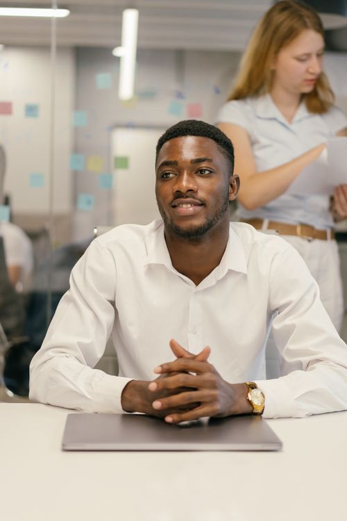 Free Portrait of a confident businessman at the office desk during a day meeting in a modern workspace. Stock Photo