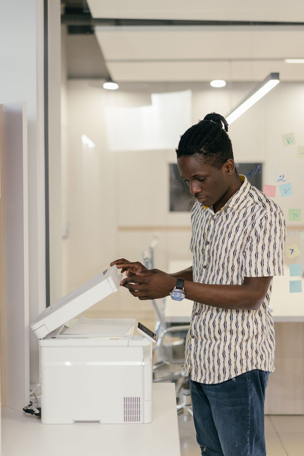 Technician servicing a photocopier and printer