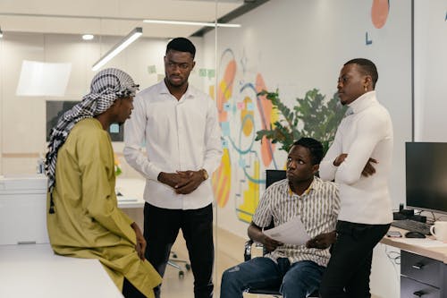 Employees Having a Conversation Inside the Office