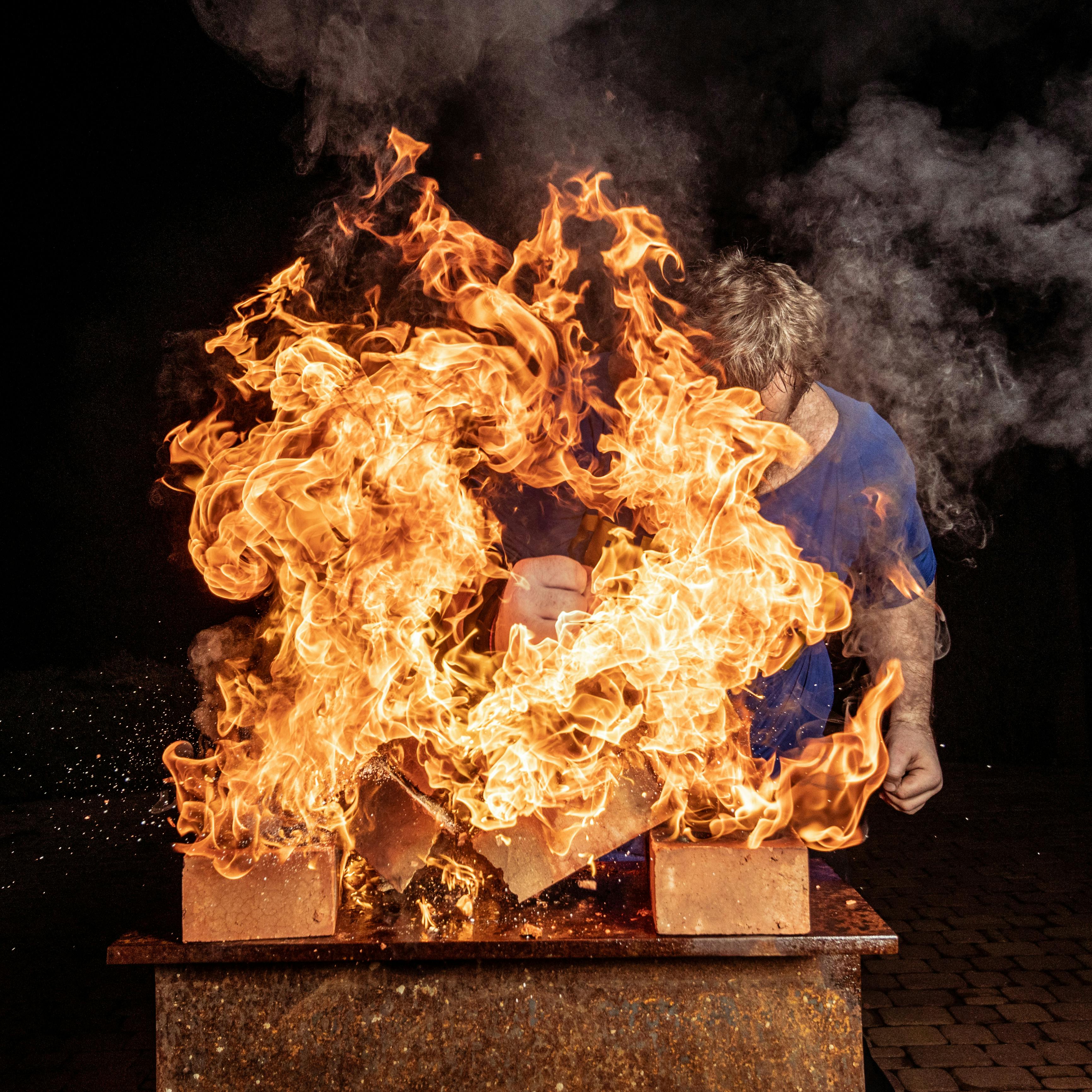 man near the burning boxes