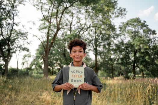 Boy Holding Scout Field Book in Hands