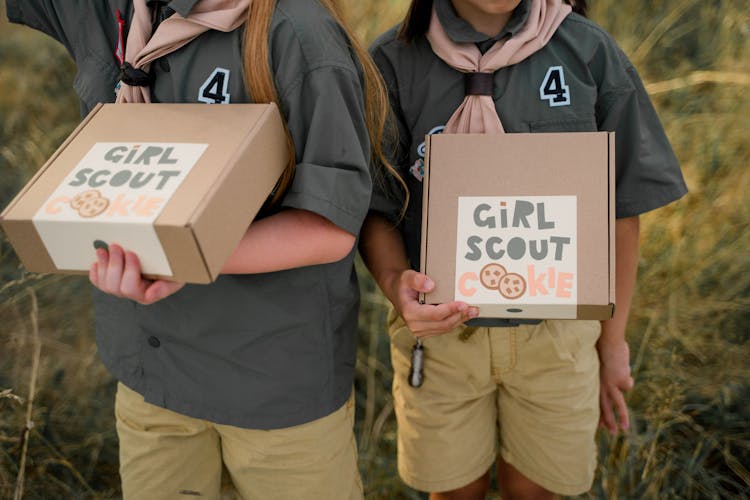 Unrecognizable Girl Scouts Holding Cardboard Boxes