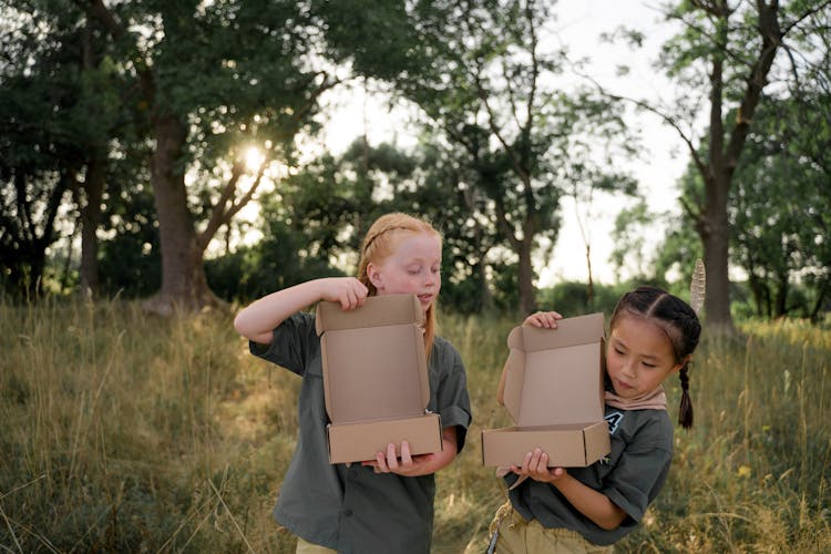 Two Girls Holding Boxes