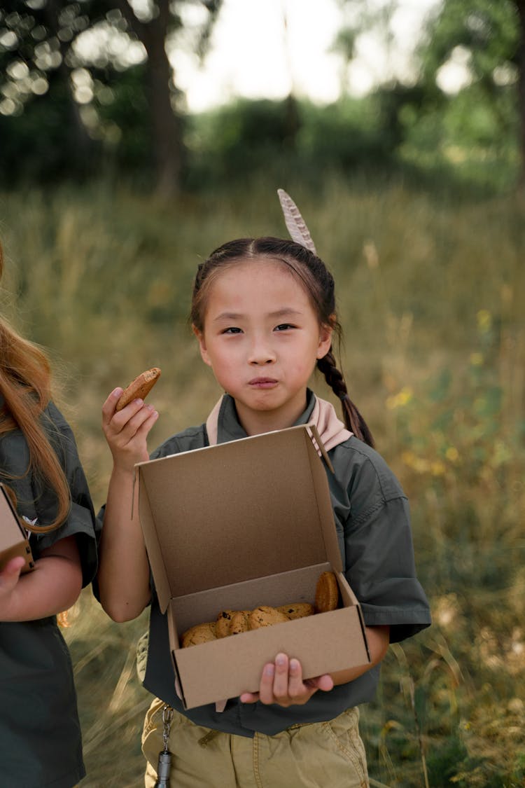 Close-Up Shot Of A Little Girl Eating Cookies