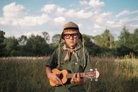 A Boys Scout Playing the Ukulele