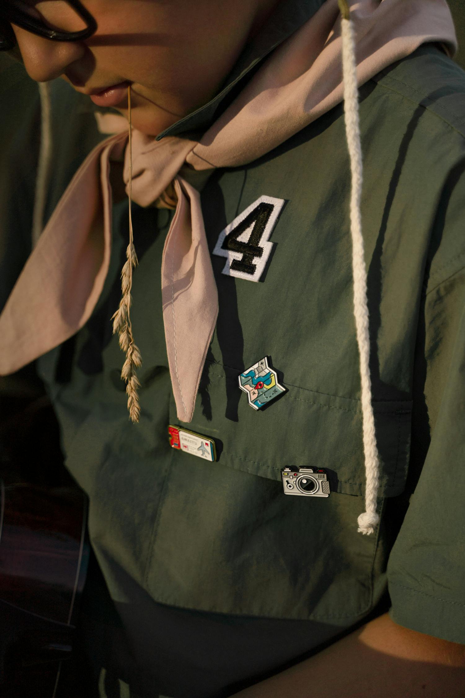 Close-up of a scout uniform showcasing badges and a neckerchief.