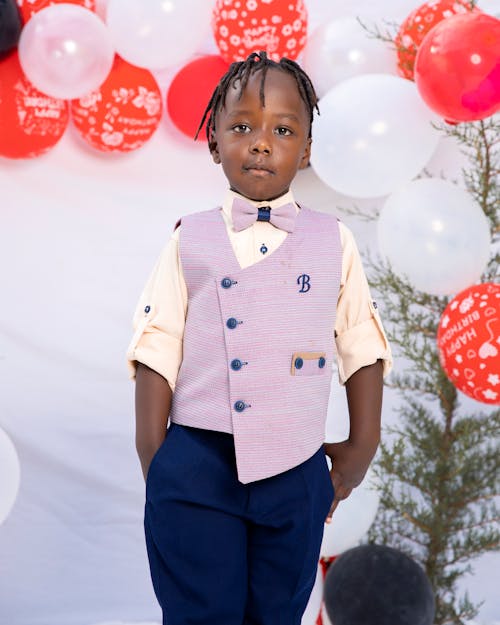 A Boy Wearing a Purple Vest with Bow Tie