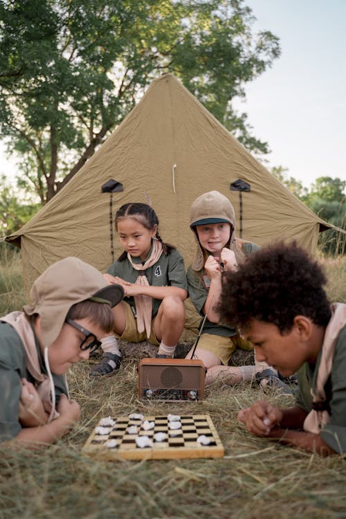 Boys Playing Board Game on Ground