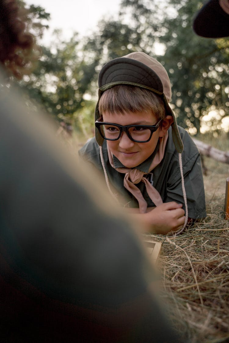 A Boy Scout Lying Prone Position On The Grass