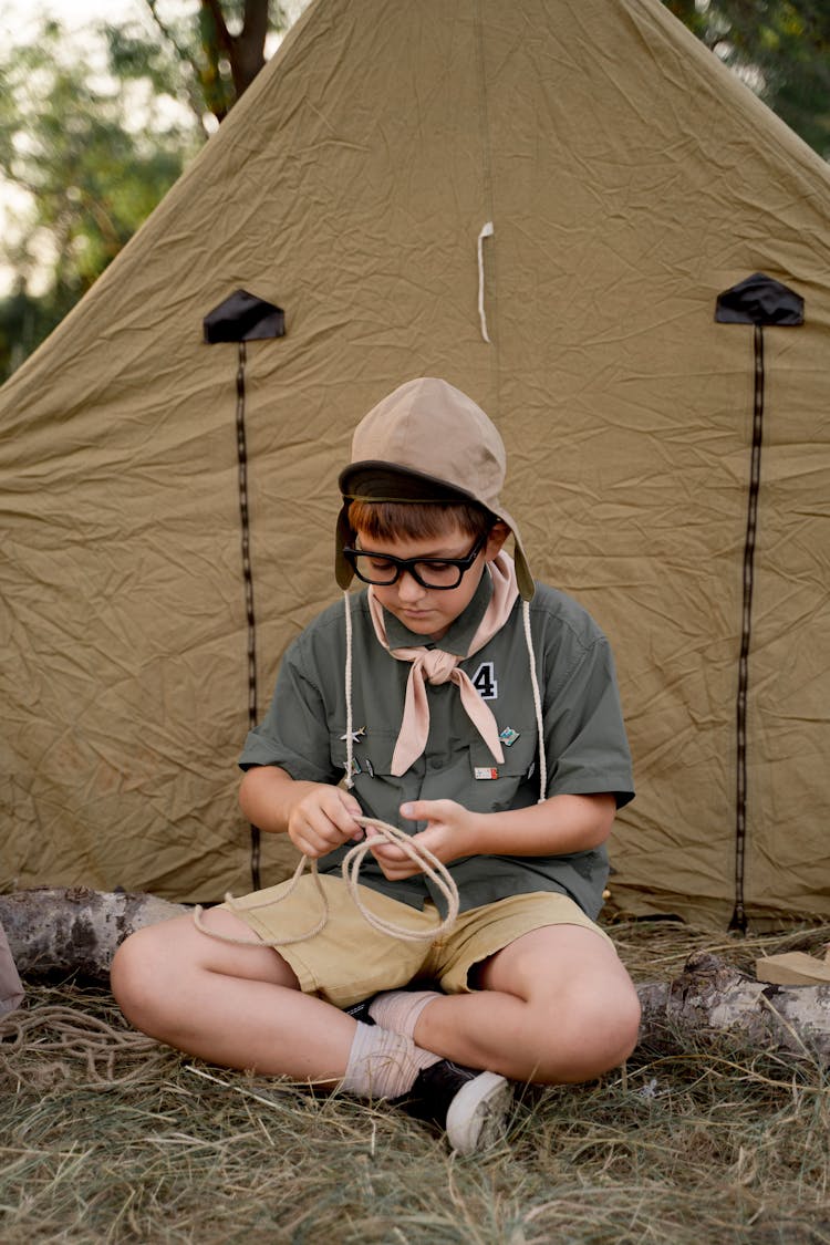 A Boy Scout Holding A Rope