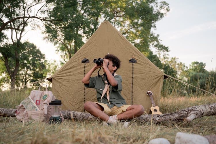 A Boy Scout Using Binoculars