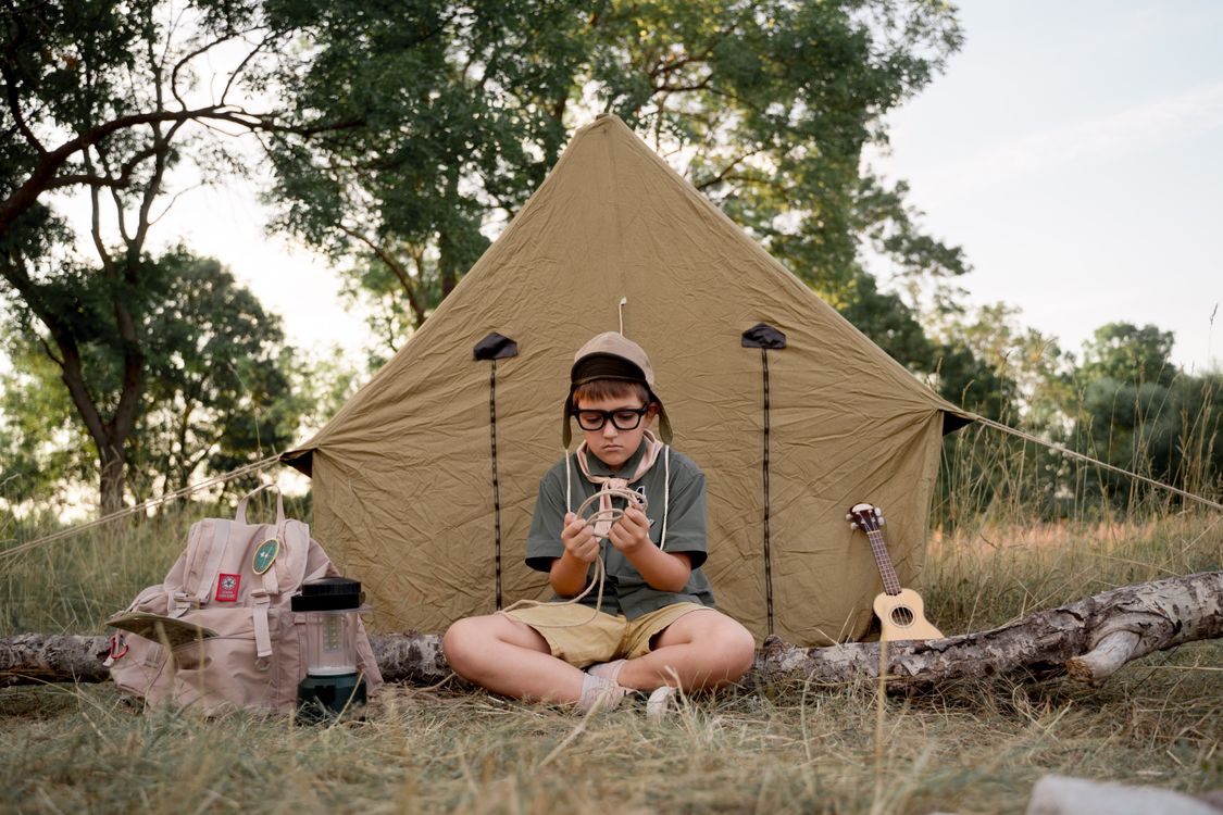 A Boy Scout Tying a Rope · Free Stock Photo