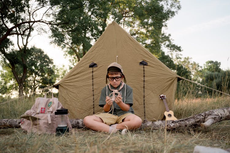 A Boy Scout Tying A Rope