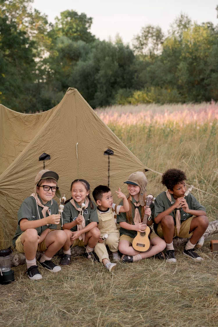 Young Scouts Sitting On A Tree Log