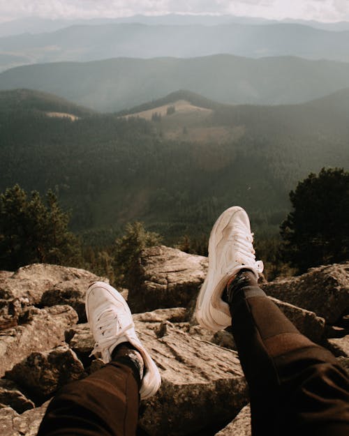 Shoes of a Man Sitting on Top of a Mountain 