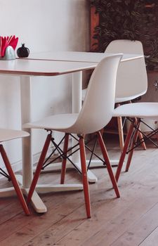 Elegant minimalist interior featuring white chairs and a table, perfect for contemporary spaces.