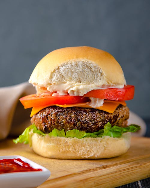 Close-up of Tasty Hamburger on Board · Free Stock Photo