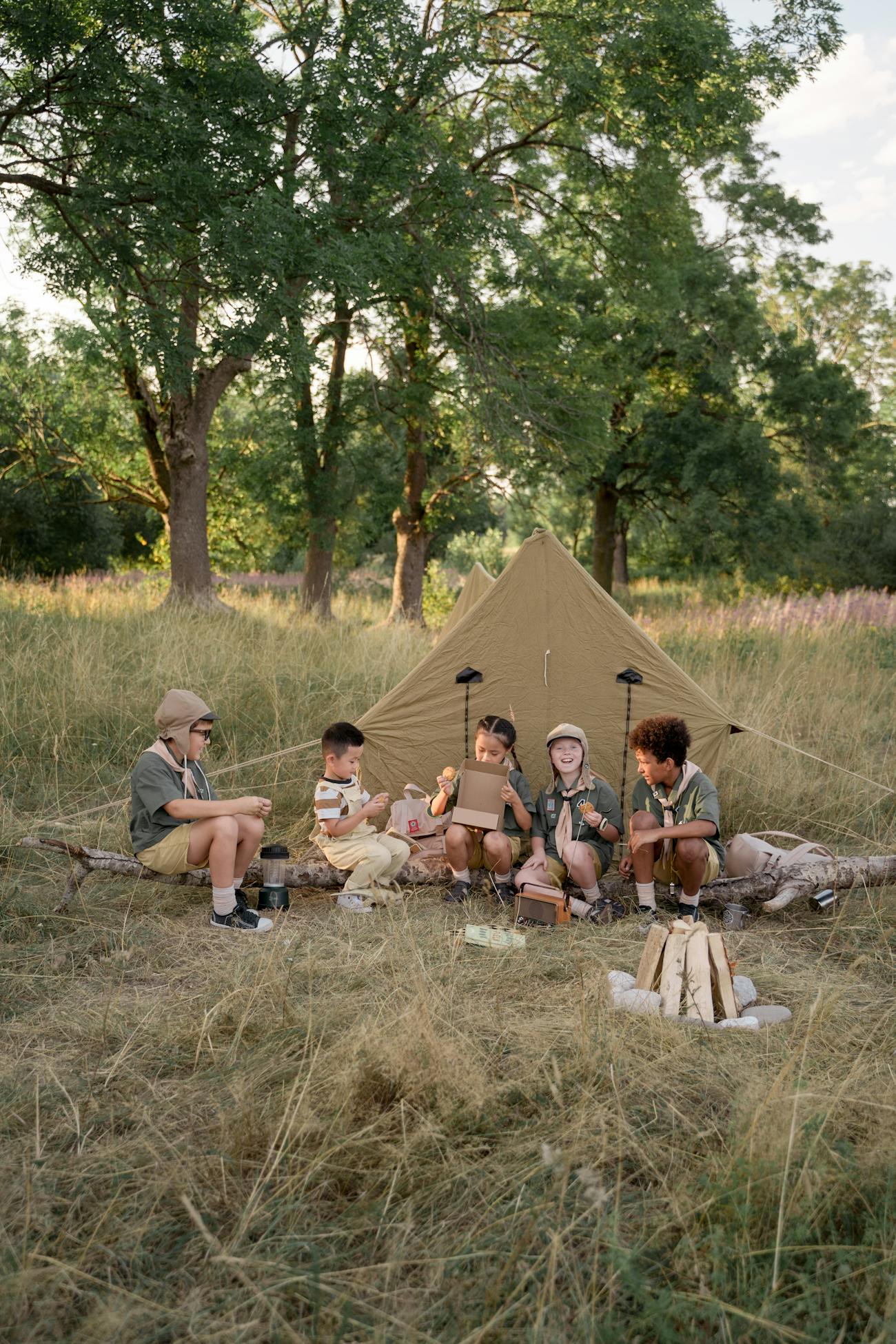 Scouts gathered at a campsite with tents in the background