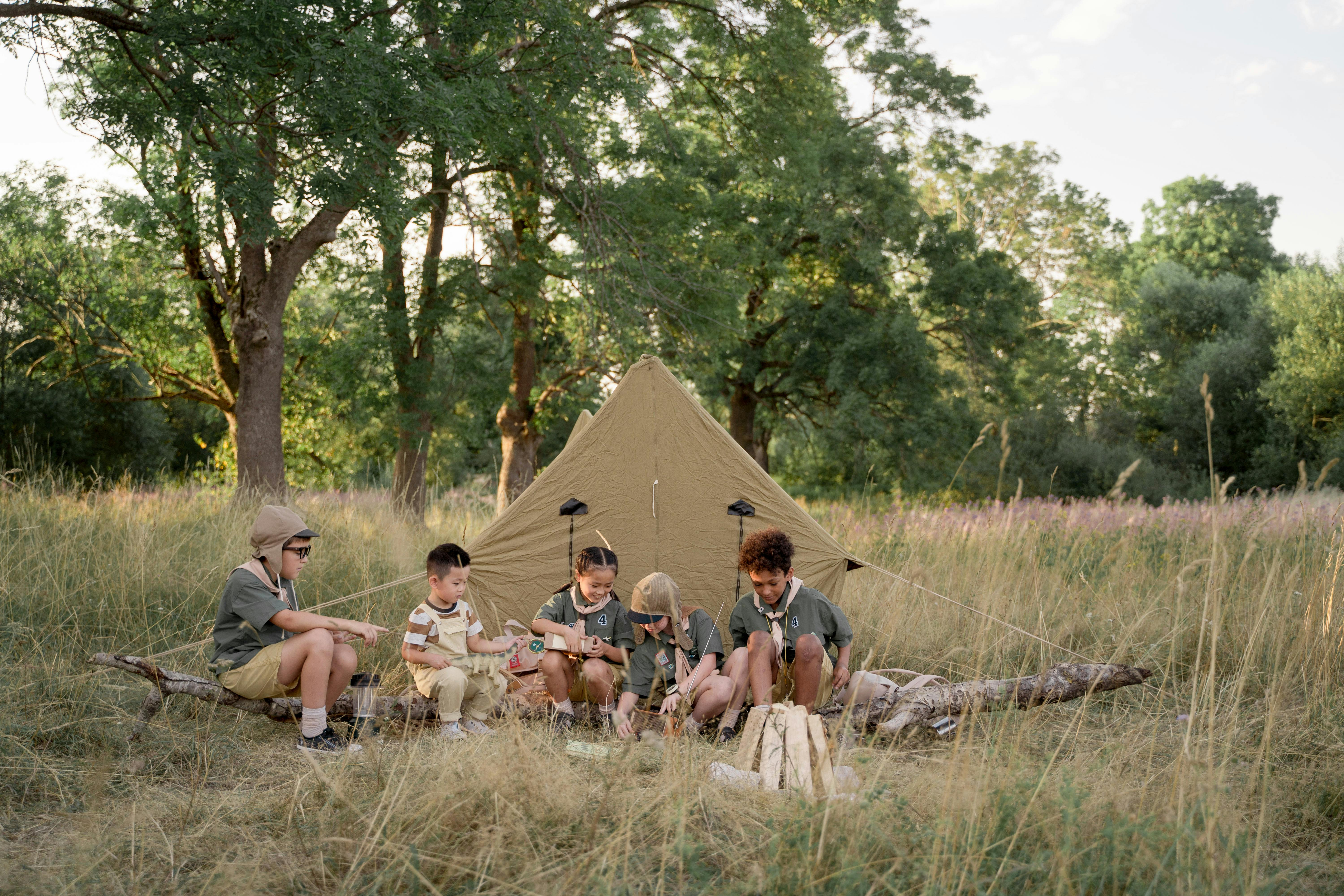 Free Multiracial Children Sitting Beside Tent Stock Photo