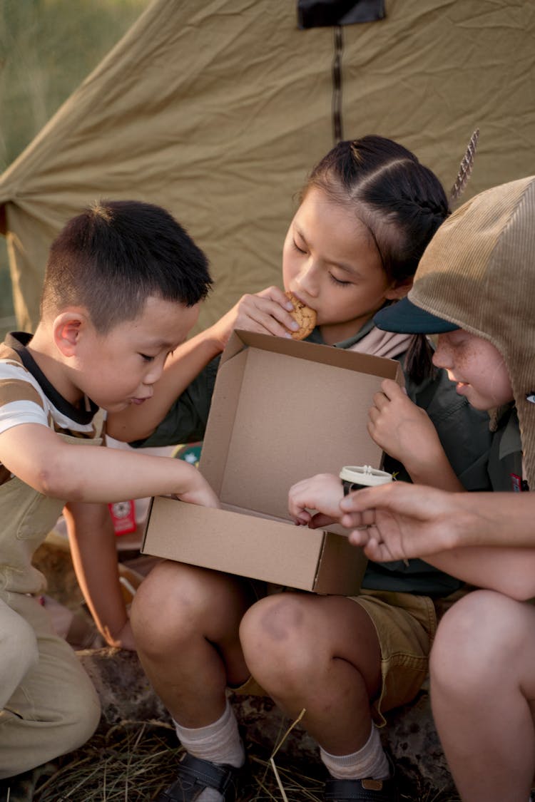 Photo Of Boys And A Girl Eating Cookies