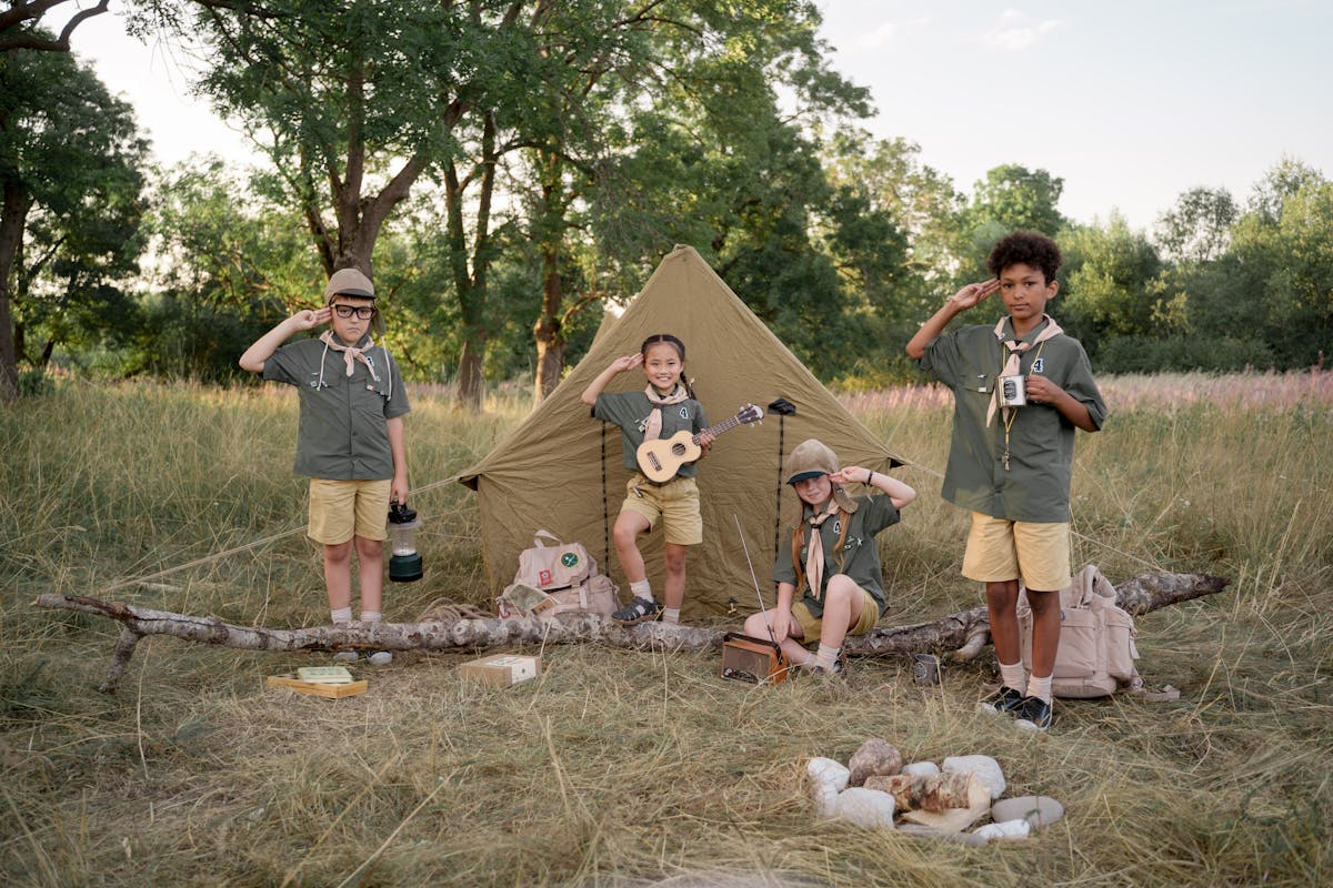 Scouts saluting together at camp