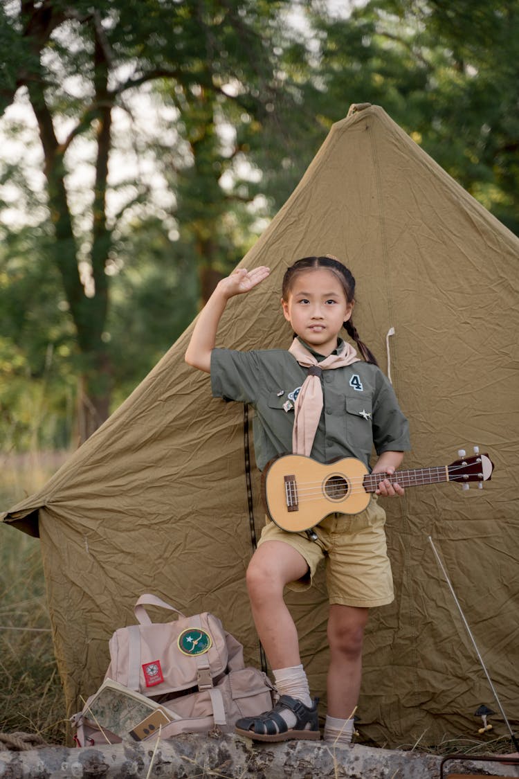 A Young Girl Holding Ukulele