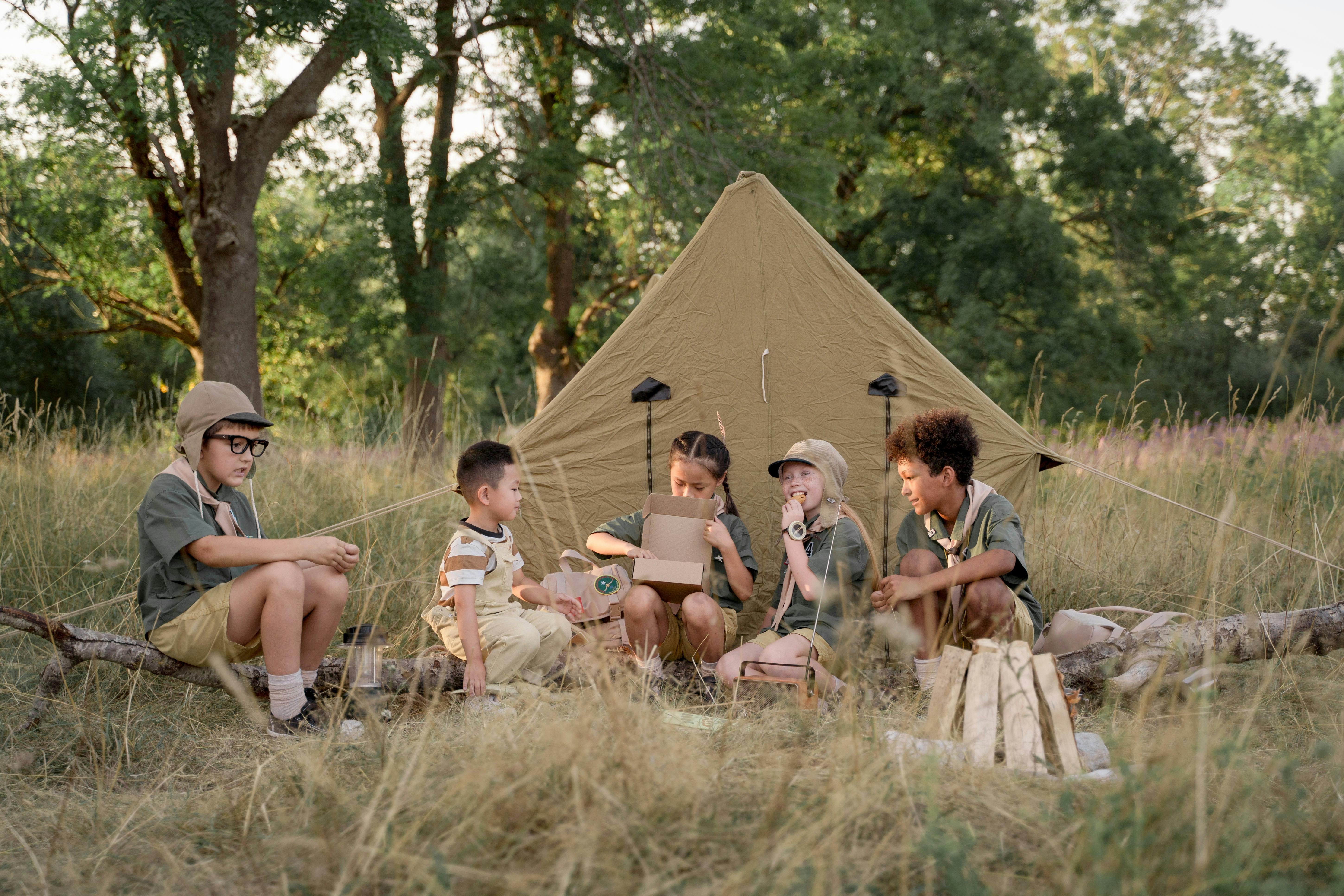 A group of children camping in the wilderness, enjoying outdoor activities and nature exploration.