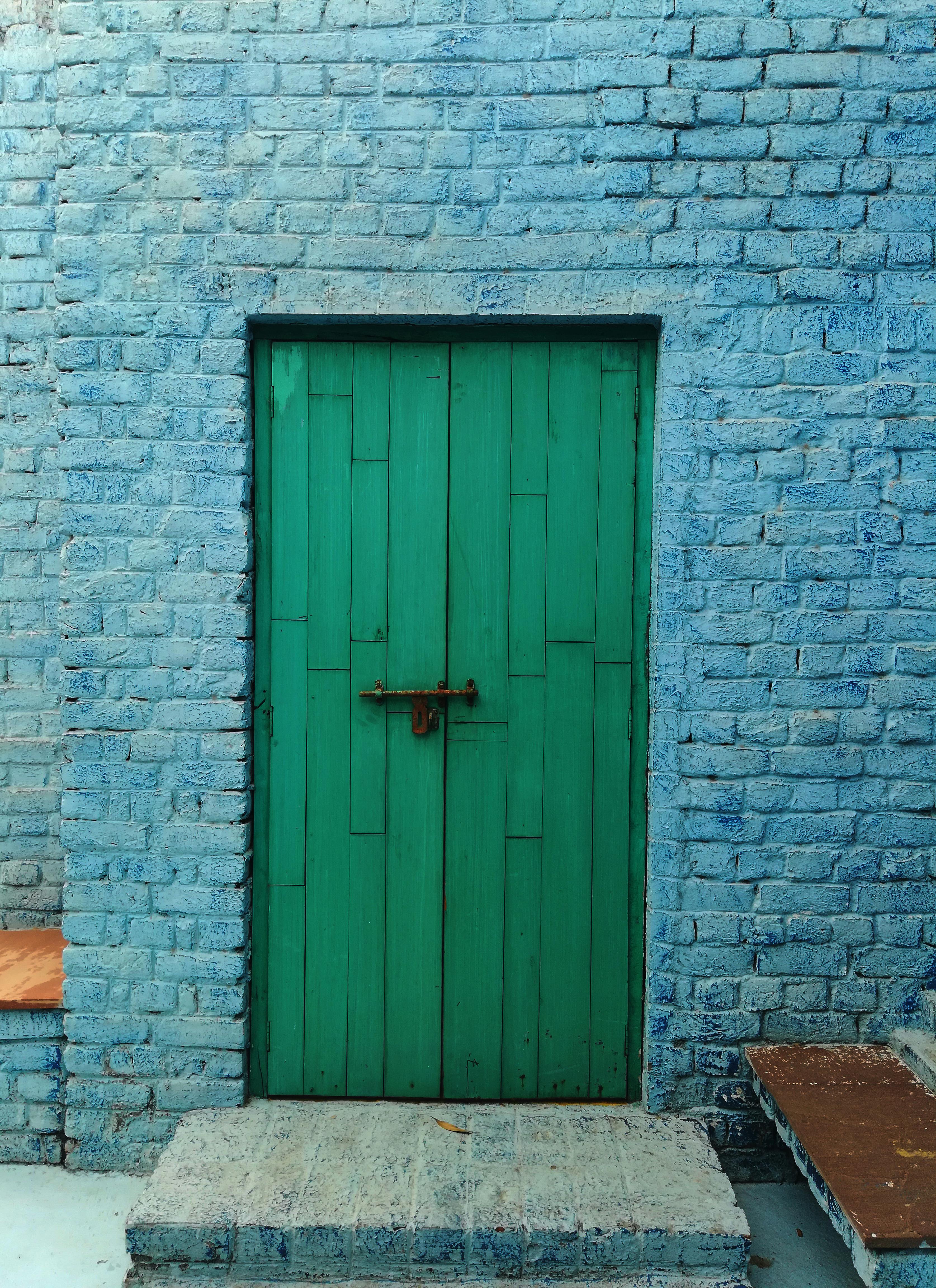 Green Wooden Door on Brick Wall · Free Stock Photo