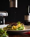 Pepper Granules Falling on a Pasta