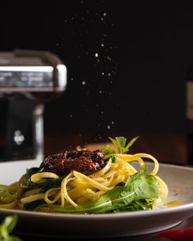 Appetizing pasta dish with sun-dried tomatoes and spinach, perfect for fine dining.
