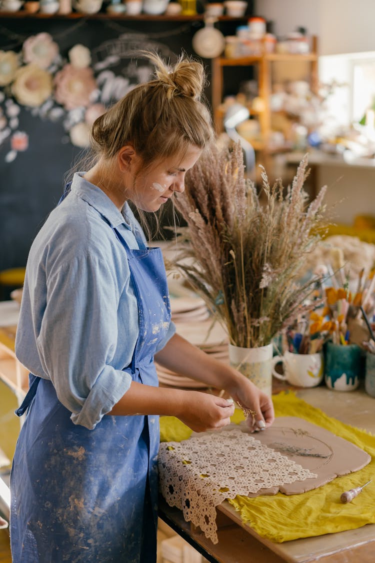 A Woman Working With Clay In The Shop