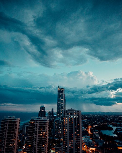 Free Capture the vibrant Gold Coast skyline with stunning moody clouds, a perfect urban sunset scene. Stock Photo