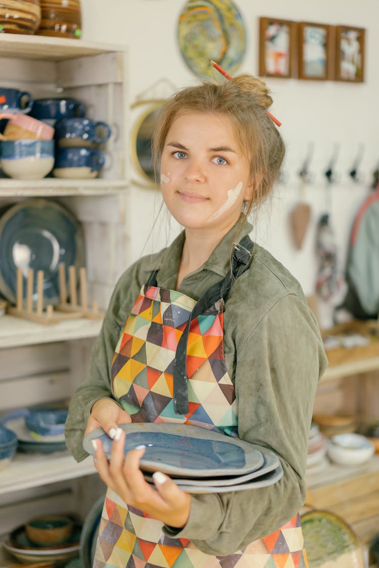 A Woman Holding Ceramic Plates