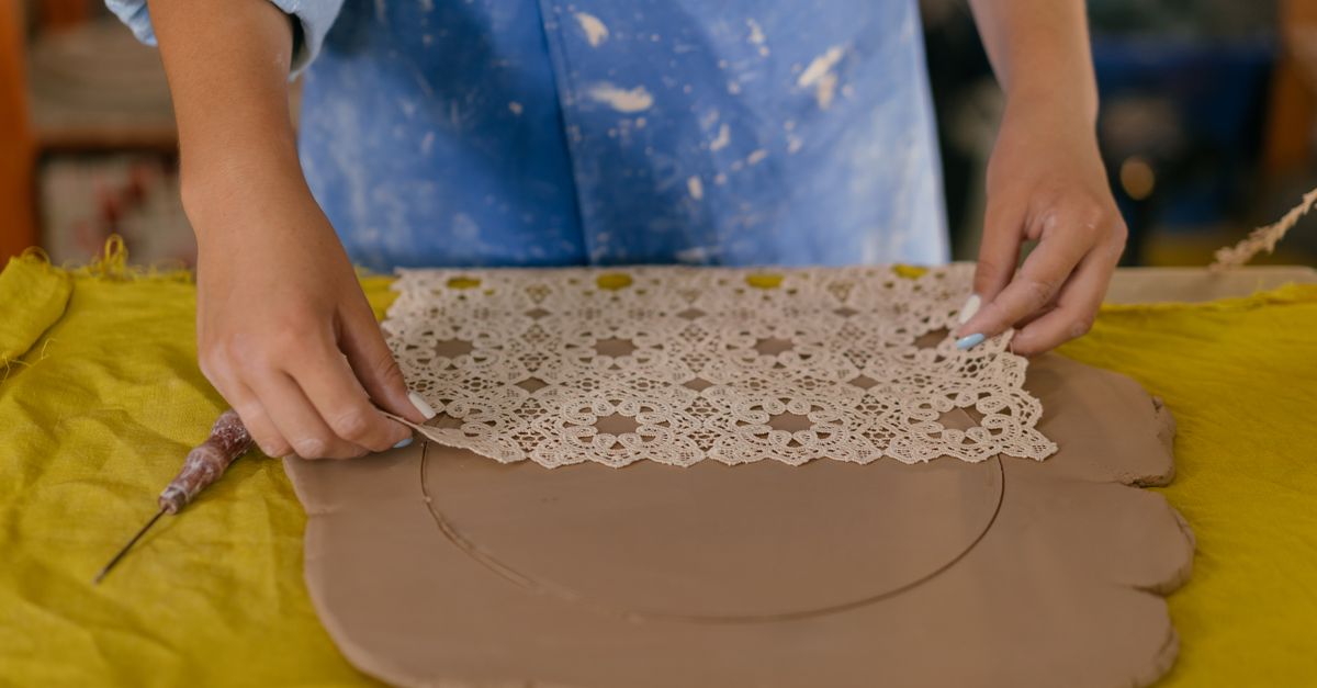 Applying Pattern Woman Potter Applying a Pattern on a Rolled Sheet of Clay · Free Stock ...