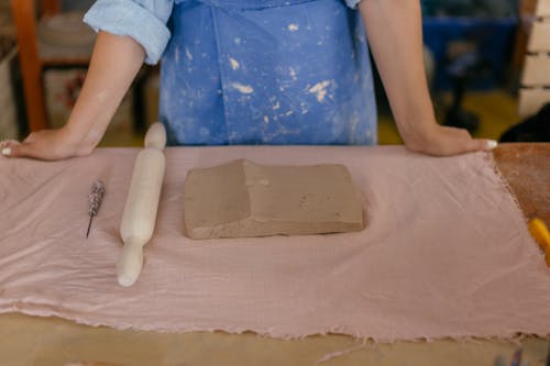A Rolling Pin Beside the Brown Clay 