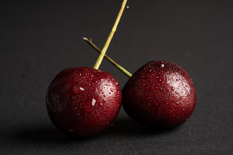 Close-Up Photograph Of Wet Cherries