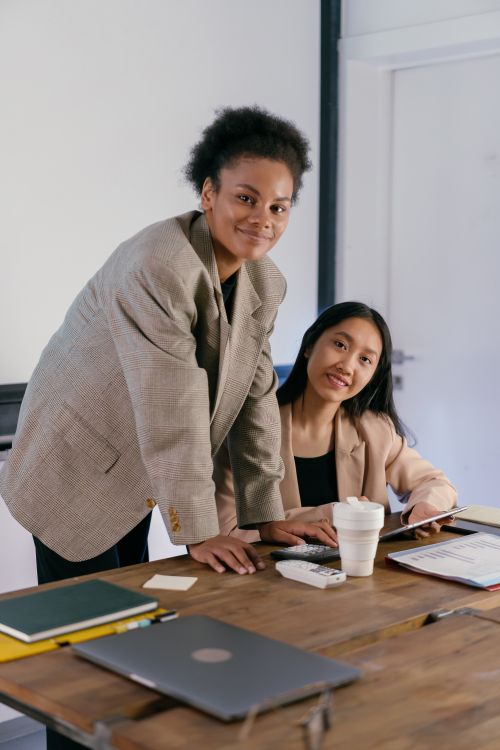 Free Confident businesswomen collaborating in a modern office environment, emphasizing teamwork. Stock Photo