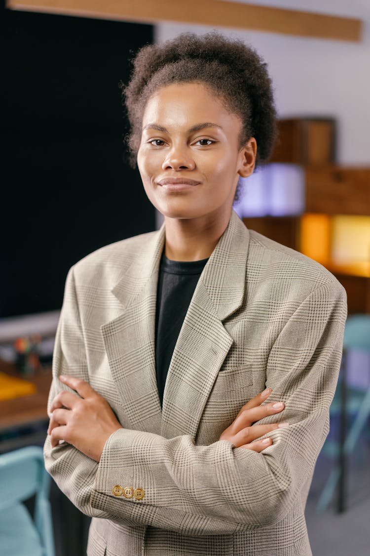 Portrait Of A Woman In A Blazer Posing With Her Arms Crossed