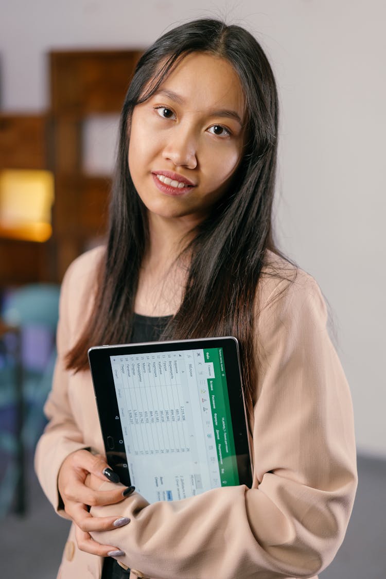 Woman In Business Attire Holding A Tablet