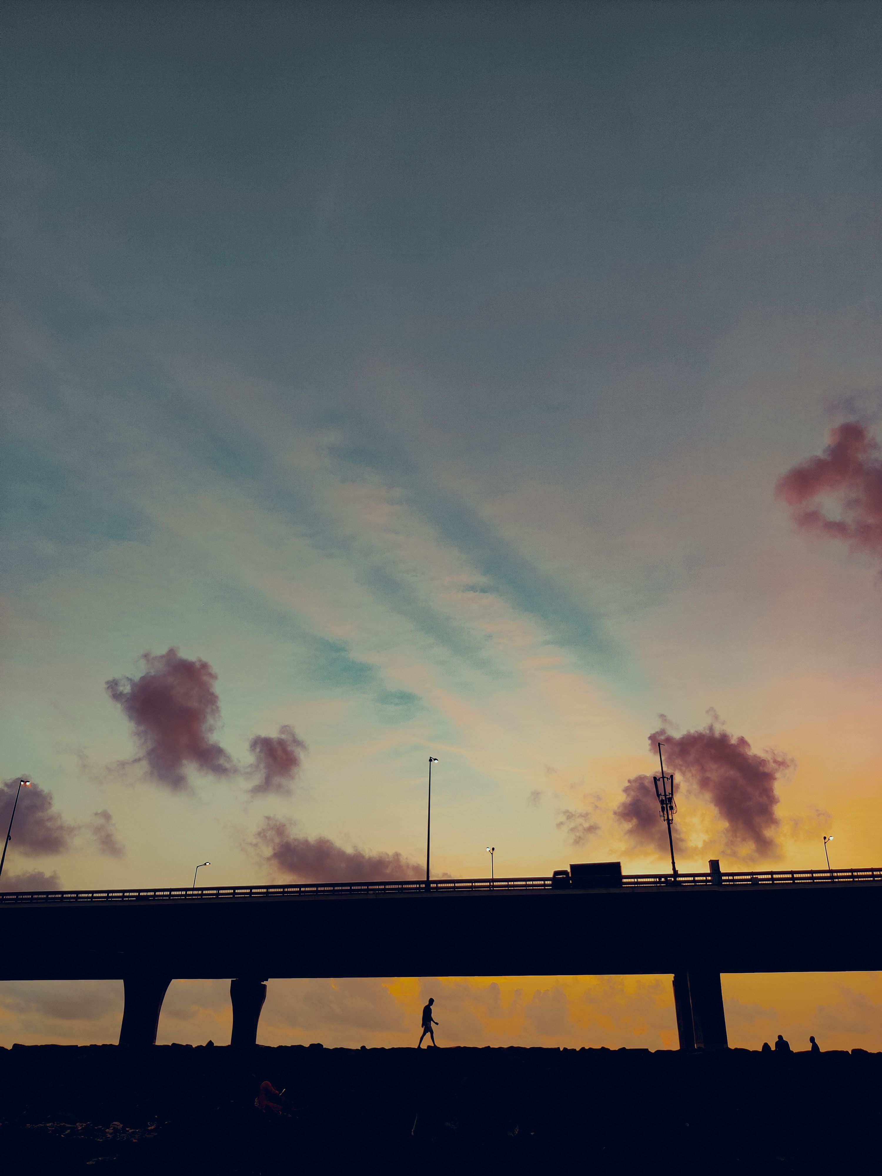 Silhouette of Person Walking Under the Bridge During Golden Hour · Free ...
