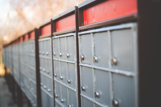 Vintage-style mailboxes in rows, showcasing safety and steel construction outdoors.
