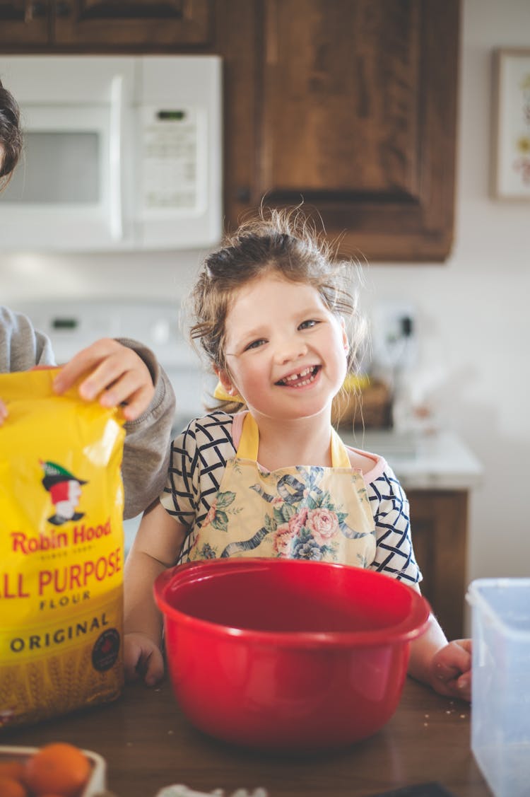 A Cute Girl In An Apron Smiling