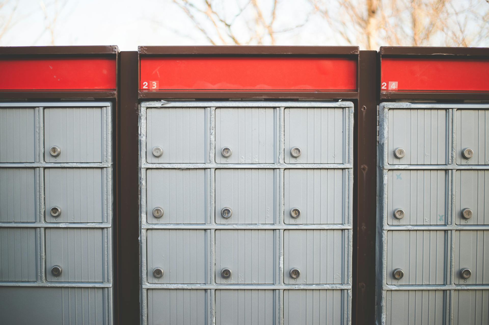 Image of secure outdoor community mailboxes with individual lockers in a row.