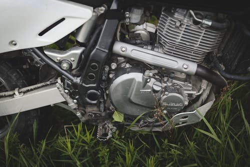 Free Black and Silver Motorcycle's Engine on Green Grass Stock Photo