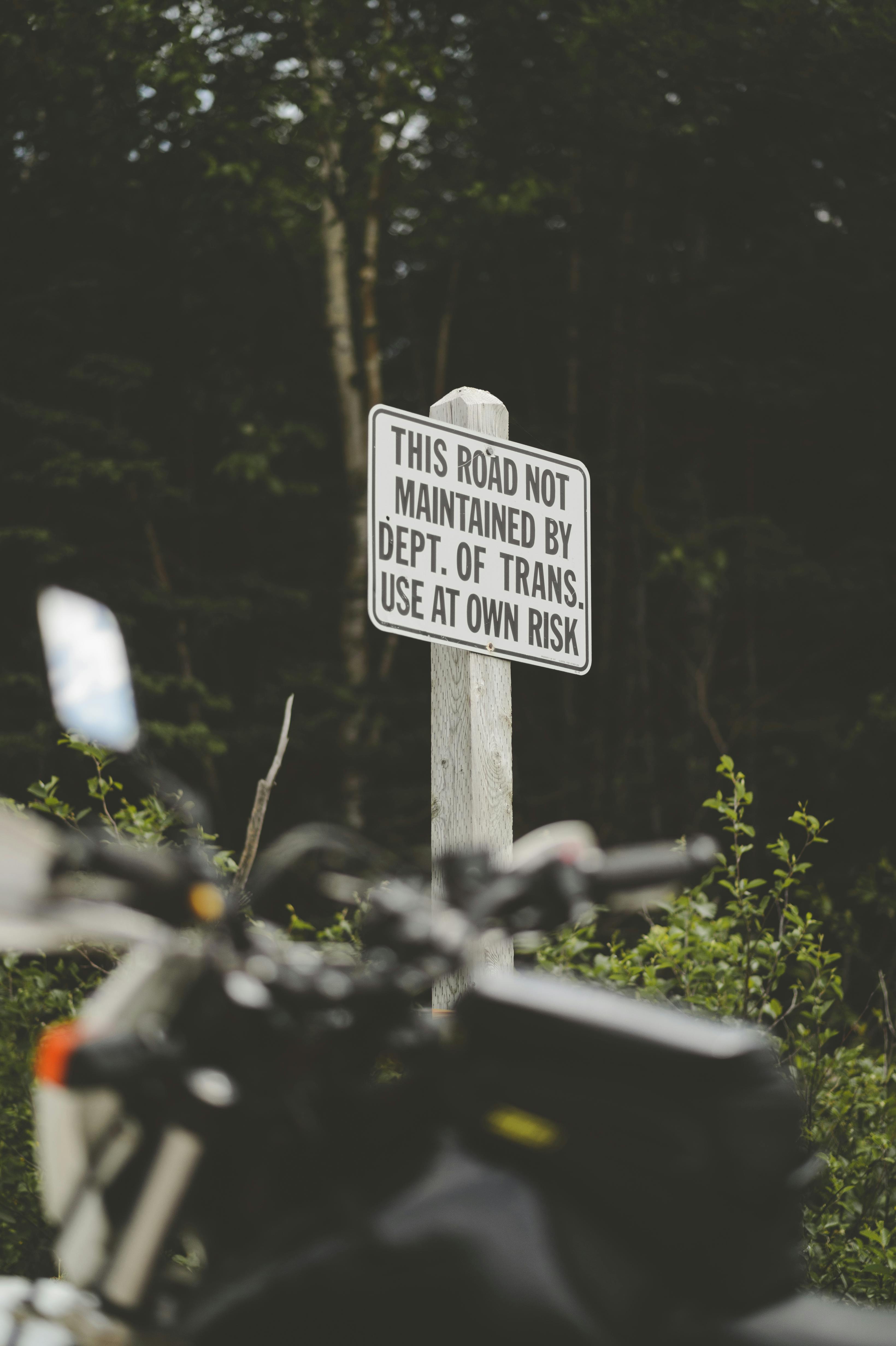 Motorcycle Beside Road Sign · Free Stock Photo