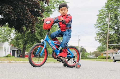 Boy Wearing Costume Riding a Bicycle