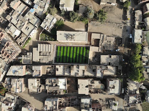 Aerial View of Football Field surrounded with Shabby Buildings 