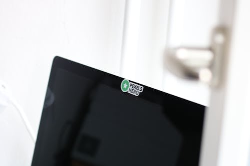 Free Closeup Photo of Opened Black Laptop Computer With Pexels Hero Sticker Stock Photo