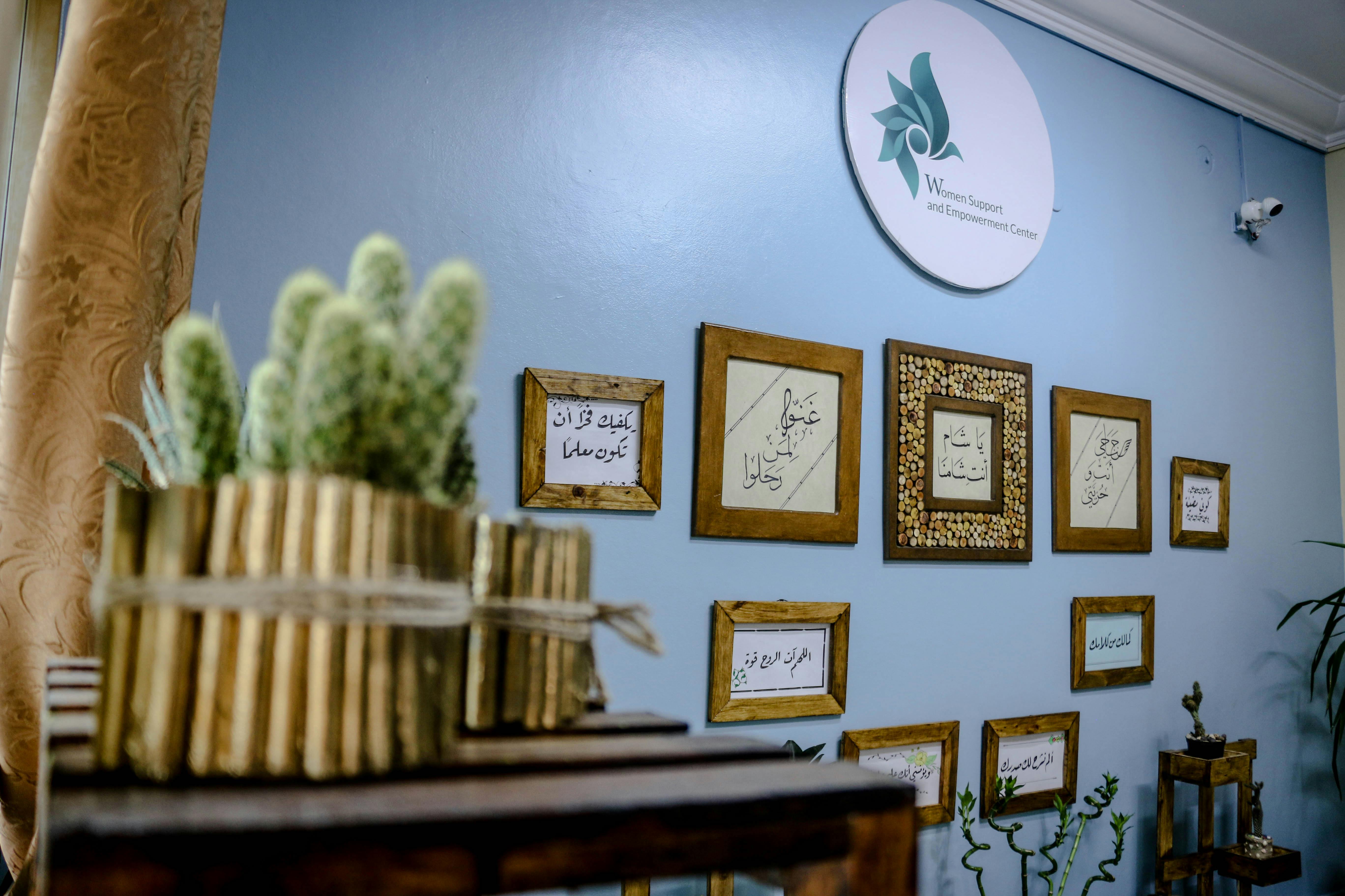 Cactus decor and framed calligraphy at a women support center in Idlib, Syria.