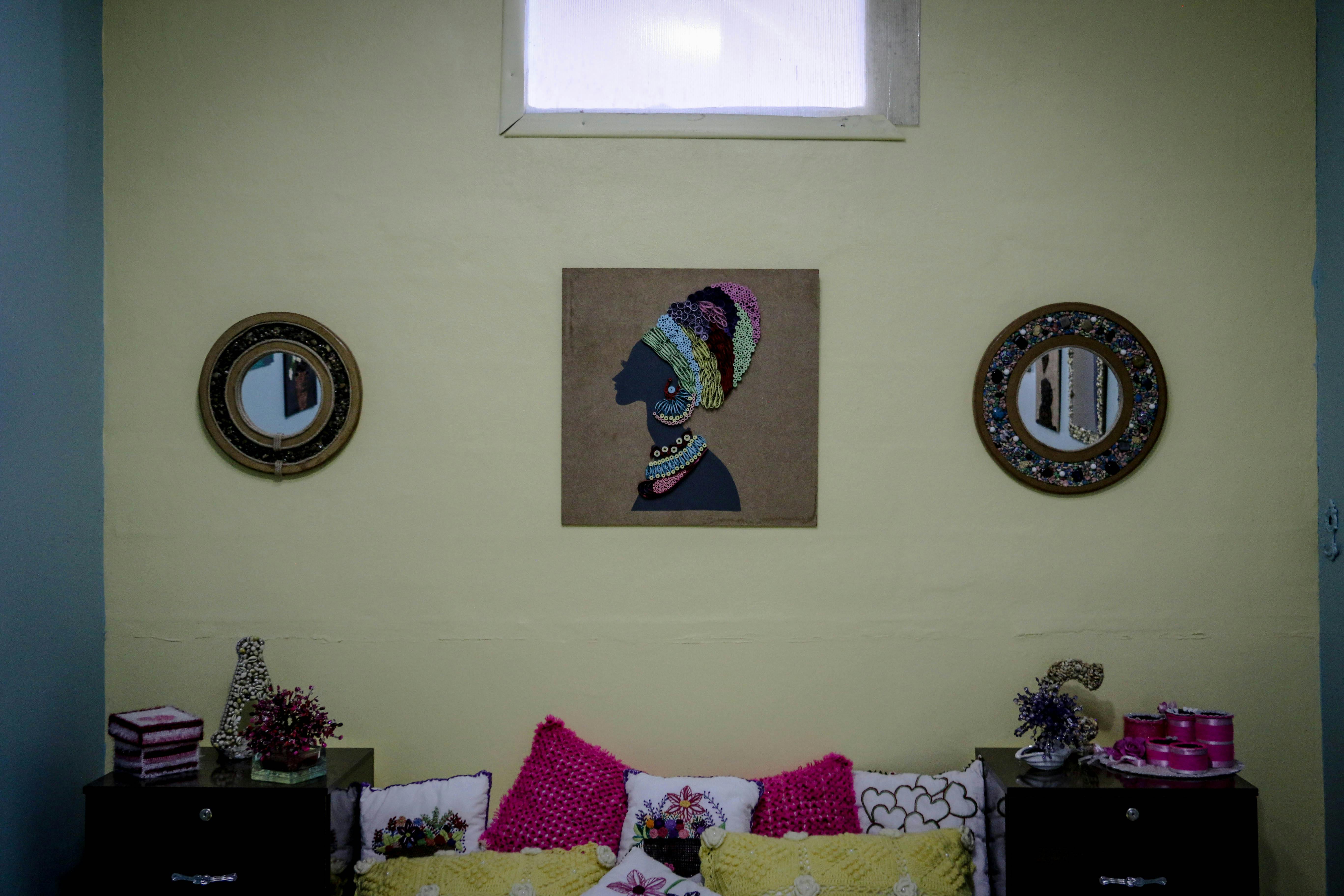 Free Stylish bedroom interior featuring a vibrant painting and ornate mirrors. Stock Photo